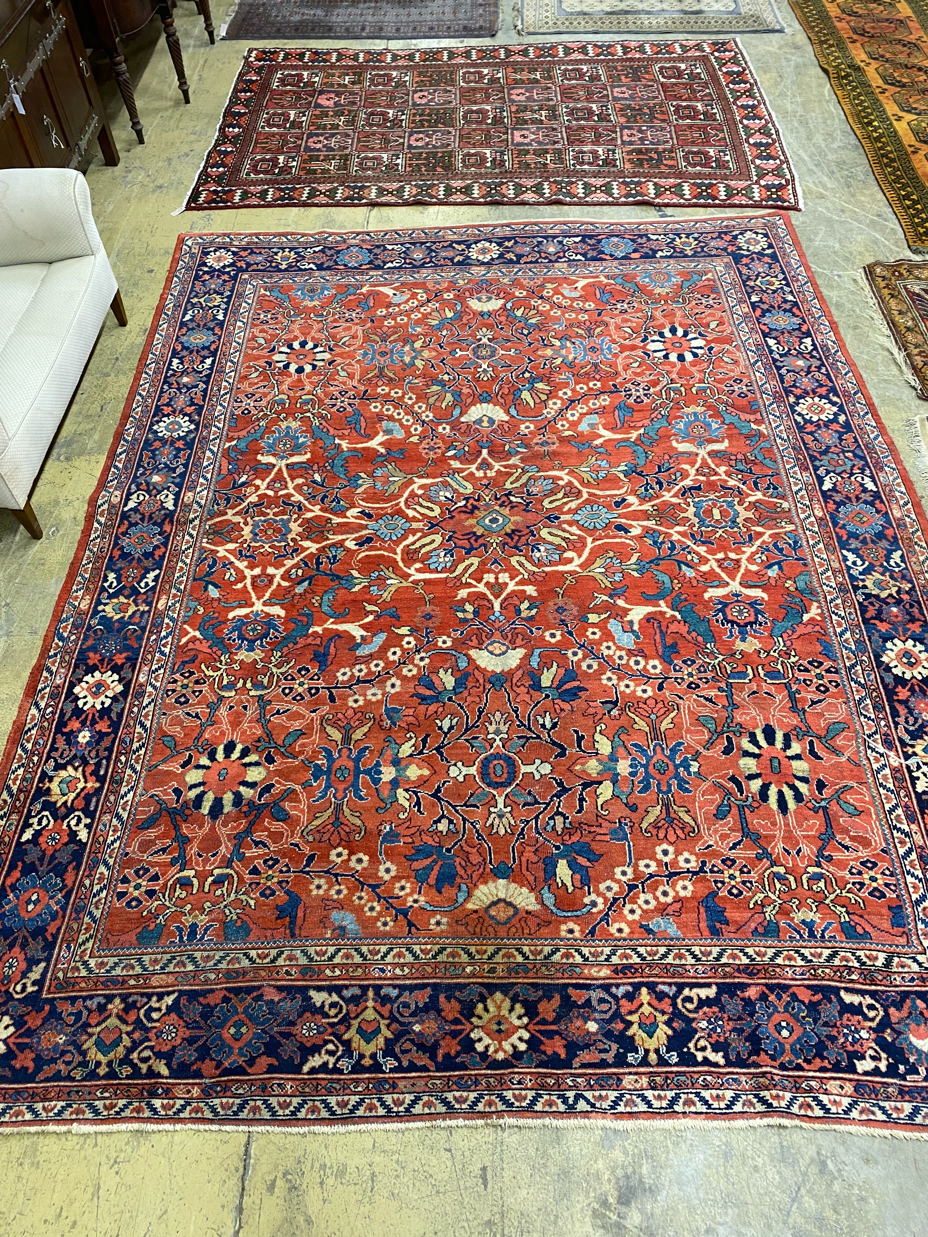 A Heriz brick red ground carpet, 364 x 280cm